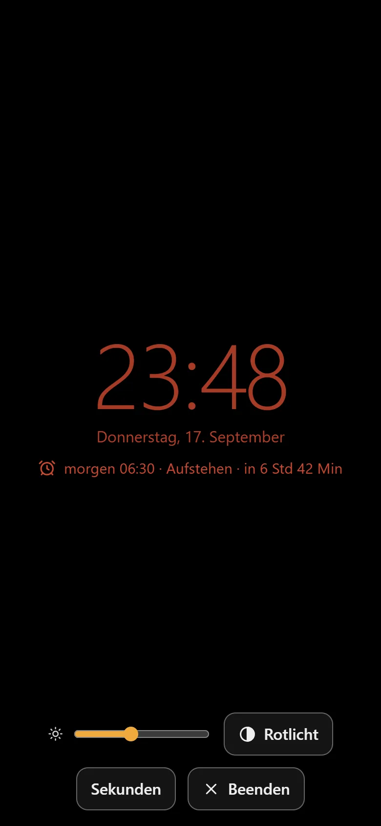 Nachttisch-Modus mit Rotlicht und Dimmer Nachttisch-Modus der Weckzentrale mit Rotlicht und eingeblendeter Leiste mit Dimmer, Rotlicht, Sekunden und Beenden